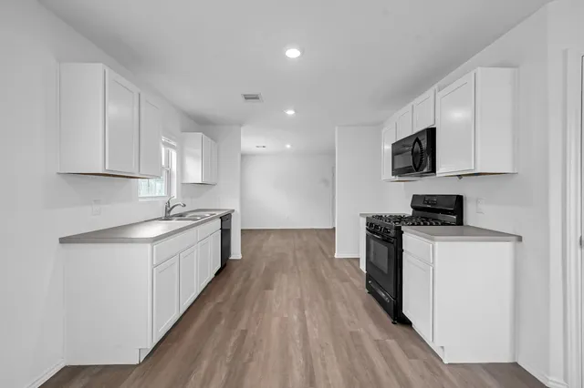 a view of a kitchen with wooden floor