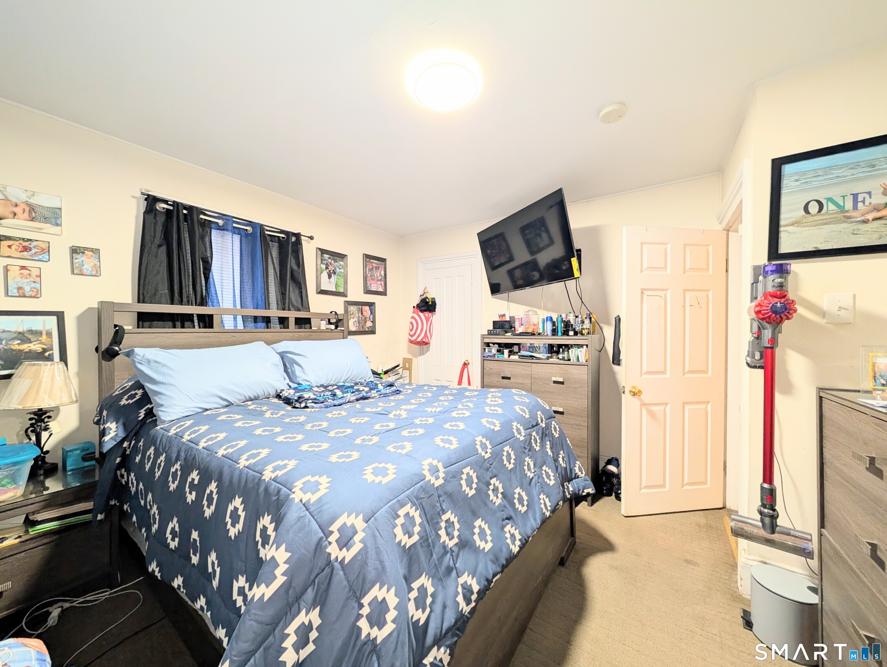 188 Holly Street Bridgeport, CT 06607 - Photo 15 of 33 a bedroom with a bed and a flat screen tv