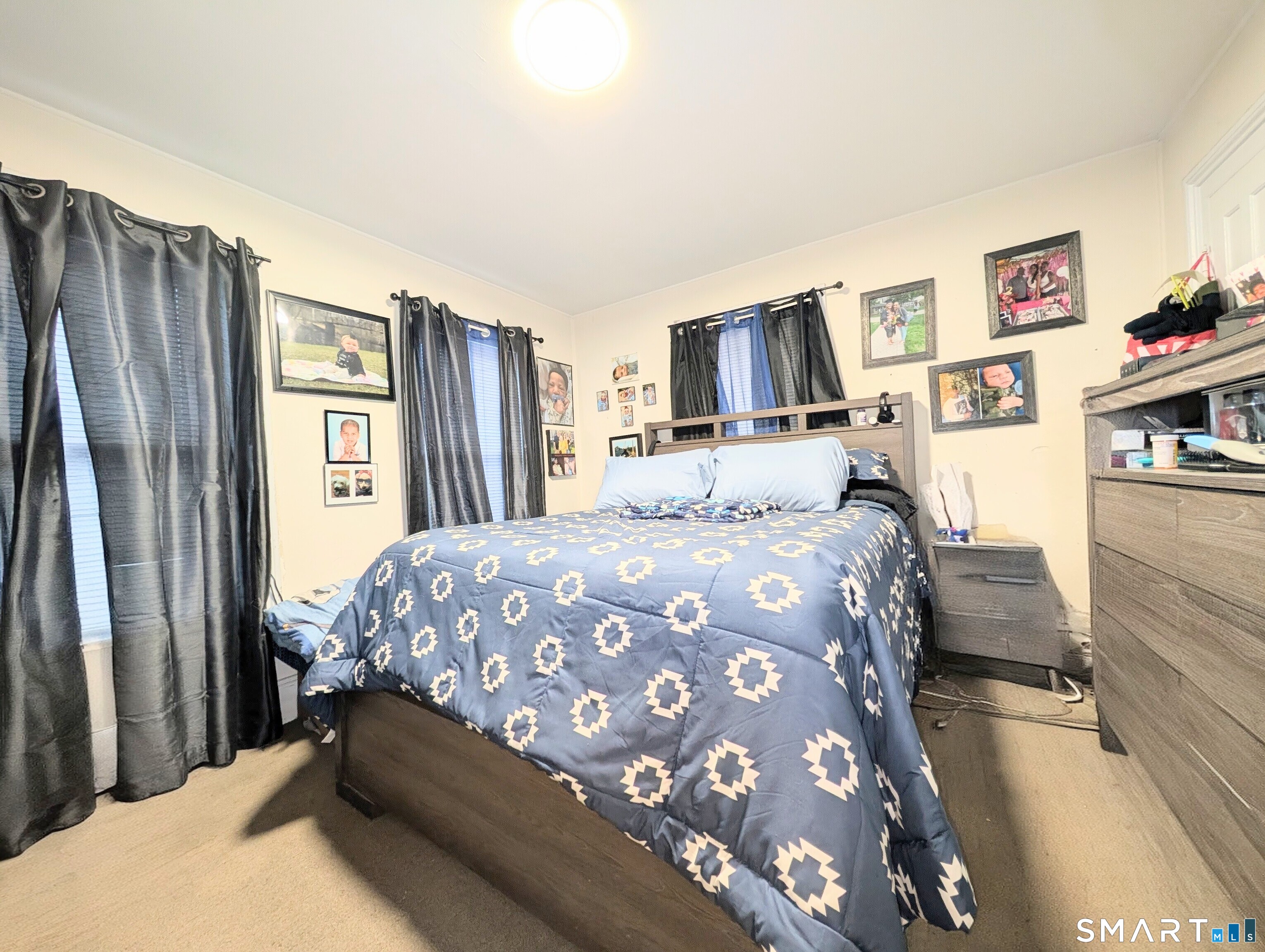 188 Holly Street Bridgeport, CT 06607 - Photo 16 of 33 a bedroom with a bed dresser and a large mirror