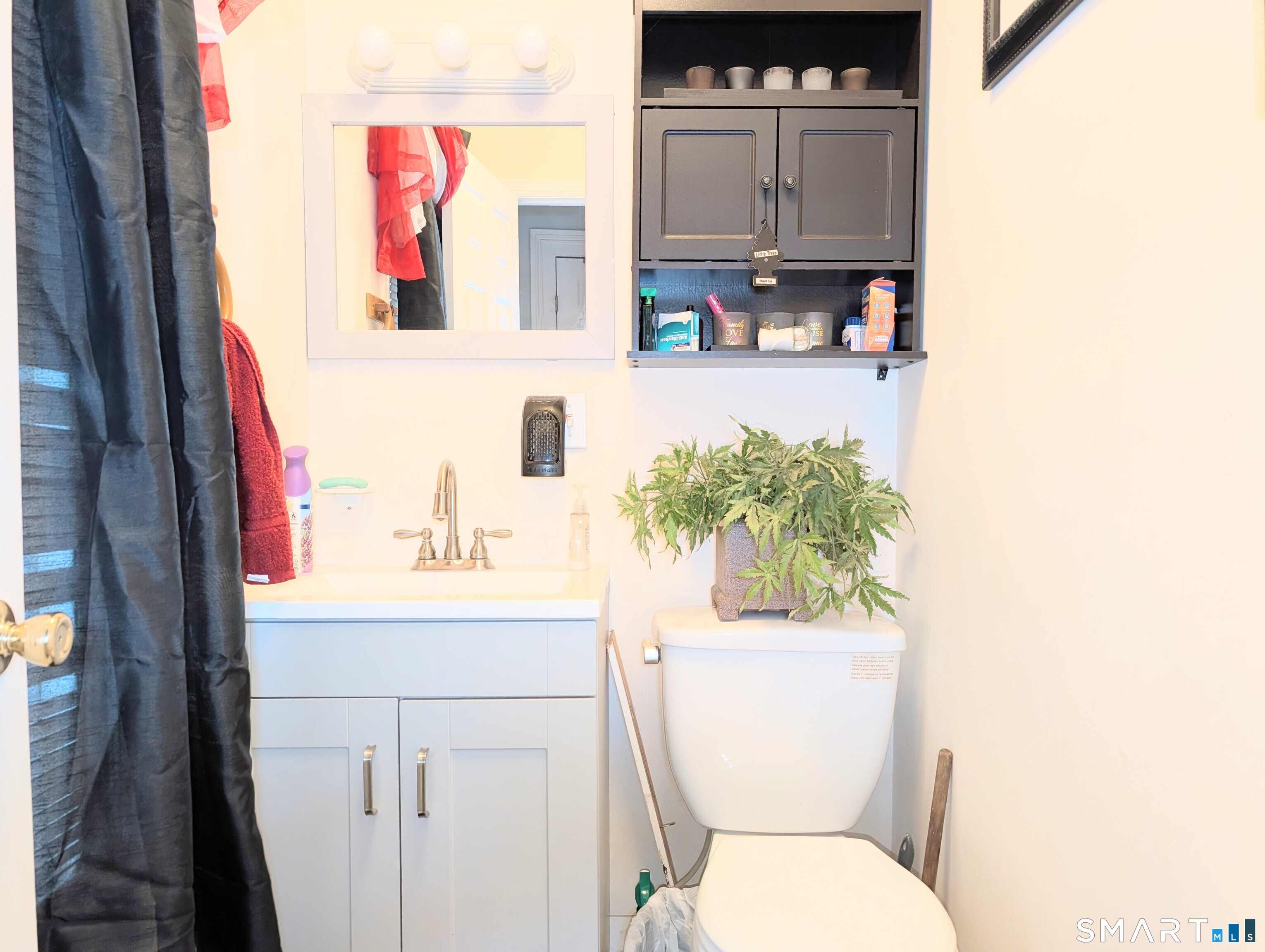 188 Holly Street Bridgeport, CT 06607 - Photo 18 of 33 a bathroom with a toilet sink and mirror