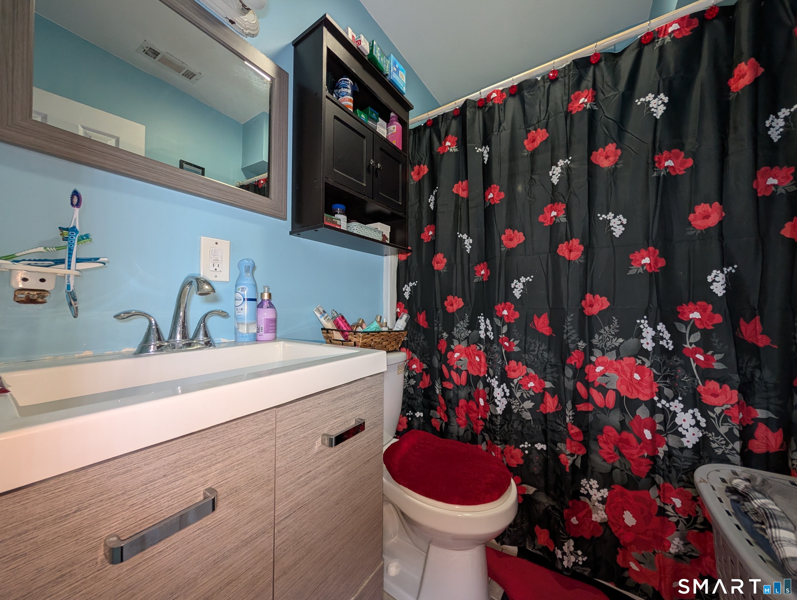 188 Holly Street Bridgeport, CT 06607 - Photo 28 of 33 a bathroom with a sink and mirror