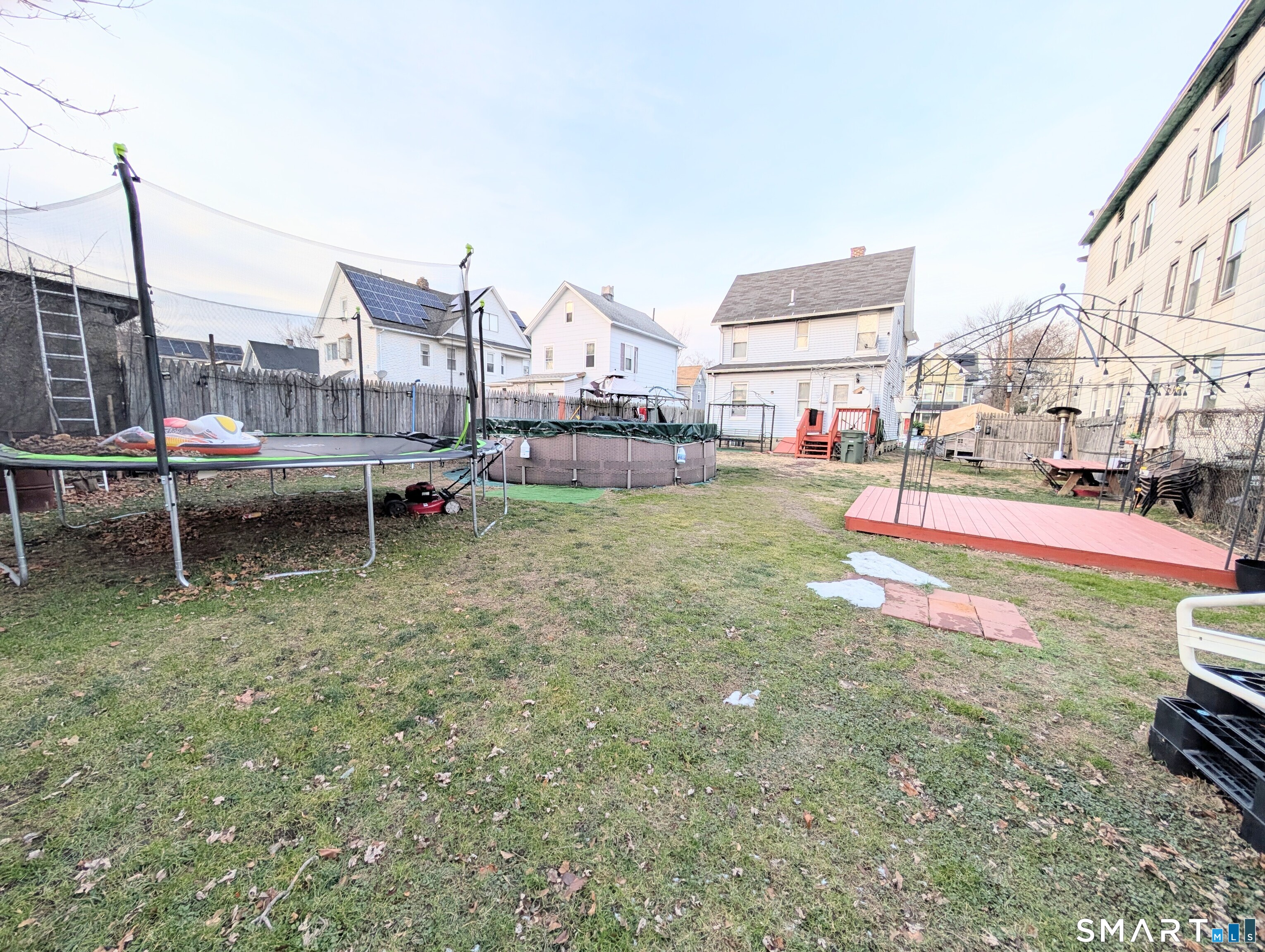 188 Holly Street Bridgeport, CT 06607 - Photo 5 of 33 a view of a swimming pool with lawn chairs and a yard