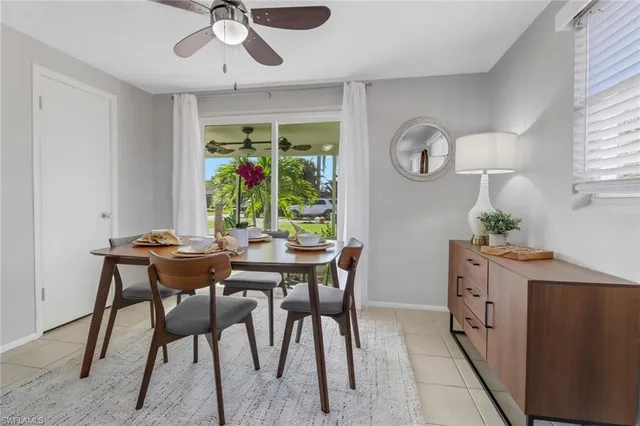 a dining room with wooden floor a chandelier a wooden table and chairs