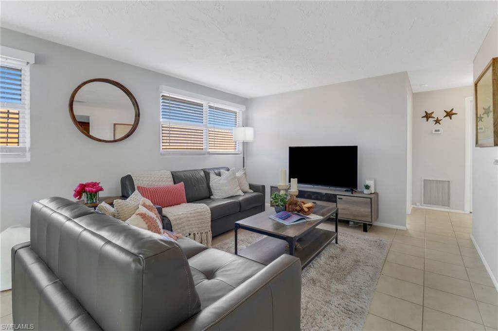 751 100th Avenue North Naples, FL 34108 - Photo 18 of 34 a living room with furniture and a flat screen tv