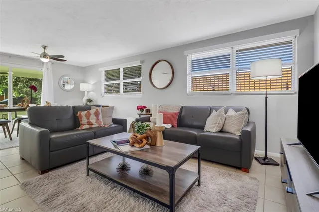 a living room with furniture a rug and a window