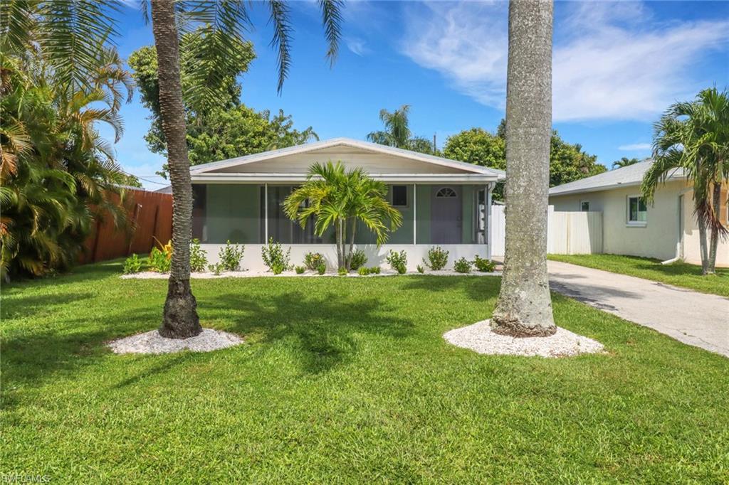751 100th Avenue North Naples, FL 34108 - Photo 2 of 34 a front view of a house with a yard