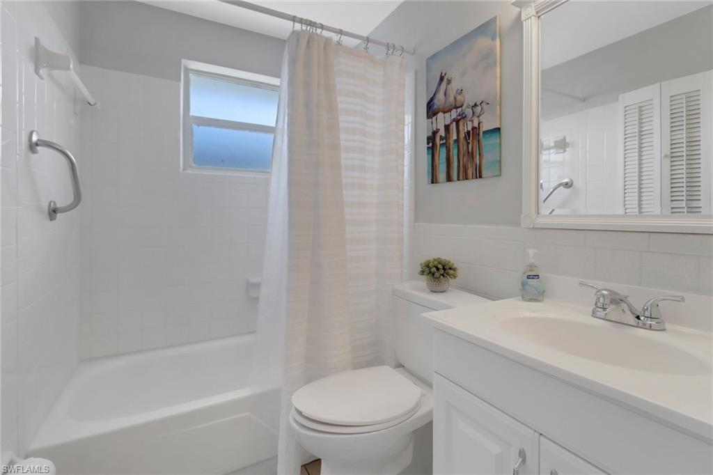 751 100th Avenue North Naples, FL 34108 - Photo 26 of 34 a bathroom with a sink a toilet and a bathtub