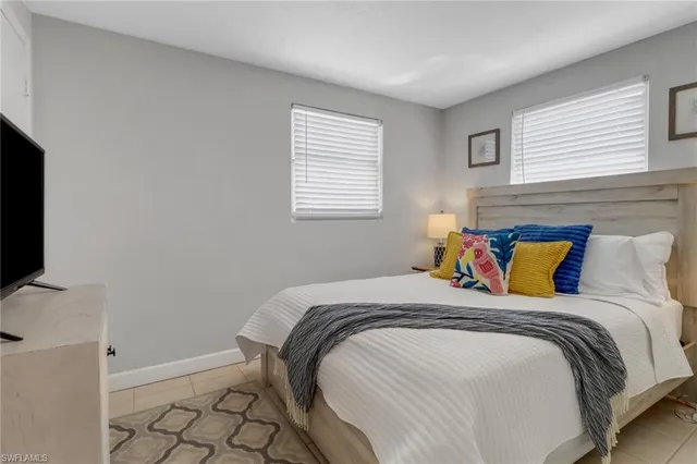 a bed sitting in a bedroom next to a window