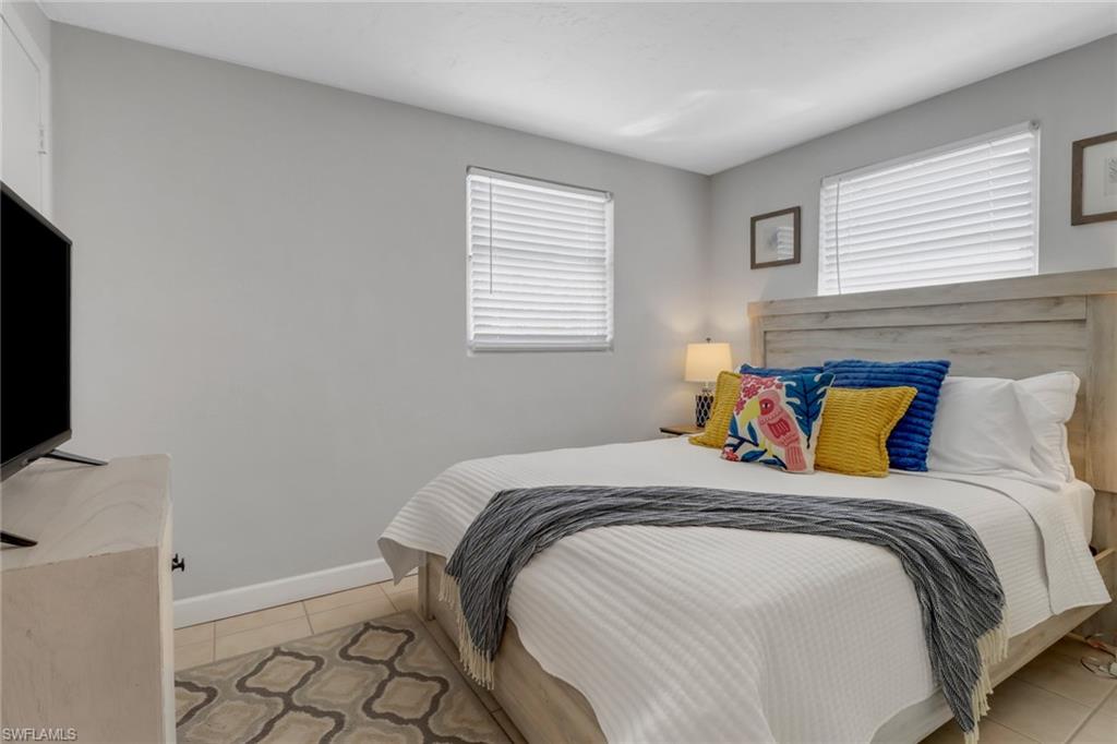 751 100th Avenue North Naples, FL 34108 - Photo 28 of 34 a bed sitting in a bedroom next to a window