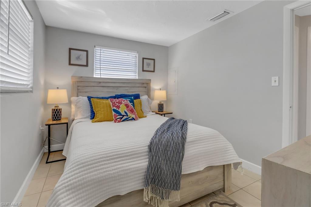 751 100th Avenue North Naples, FL 34108 - Photo 30 of 34 a bedroom with a bed and wooden floor