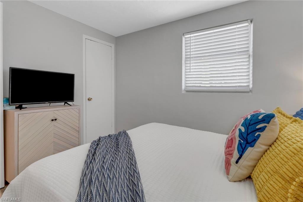 751 100th Avenue North Naples, FL 34108 - Photo 31 of 34 a bedroom with a bed and a flat screen tv