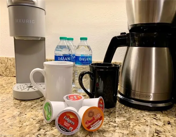 a table with a stove and a refrigerator