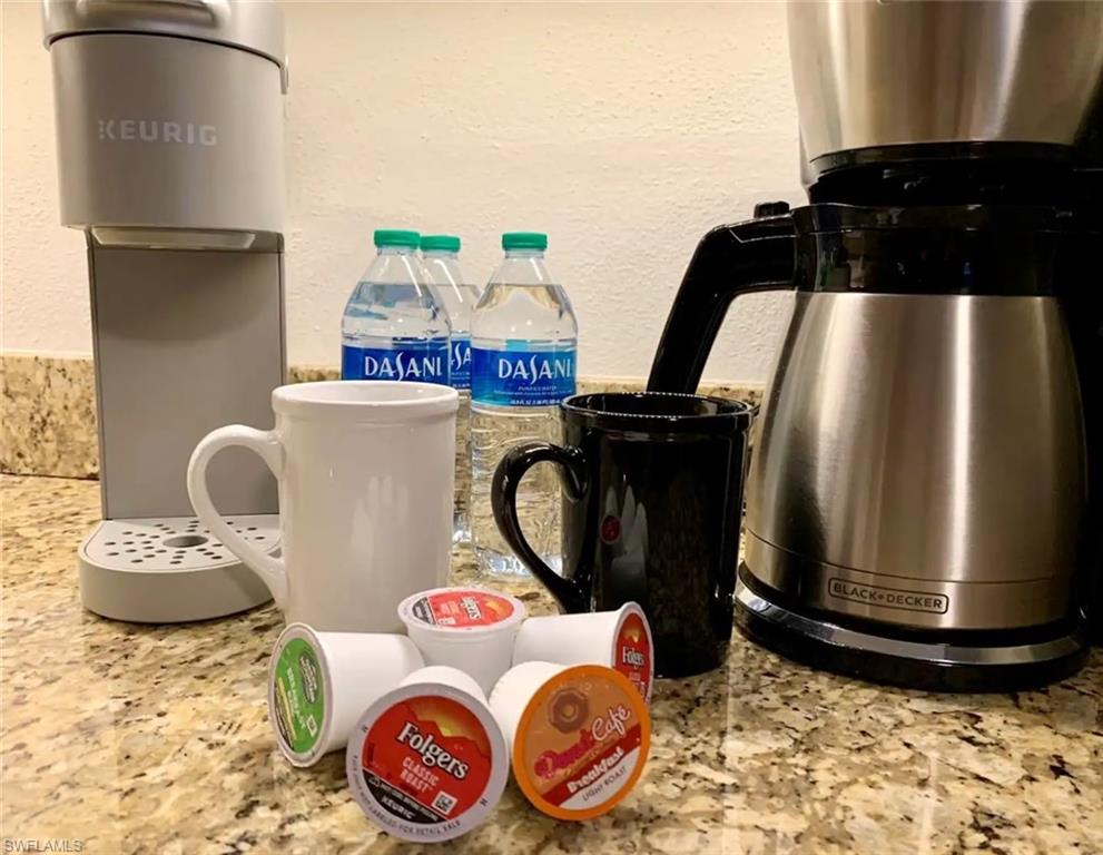751 100th Avenue North Naples, FL 34108 - Photo 32 of 34 a table with a stove and a refrigerator