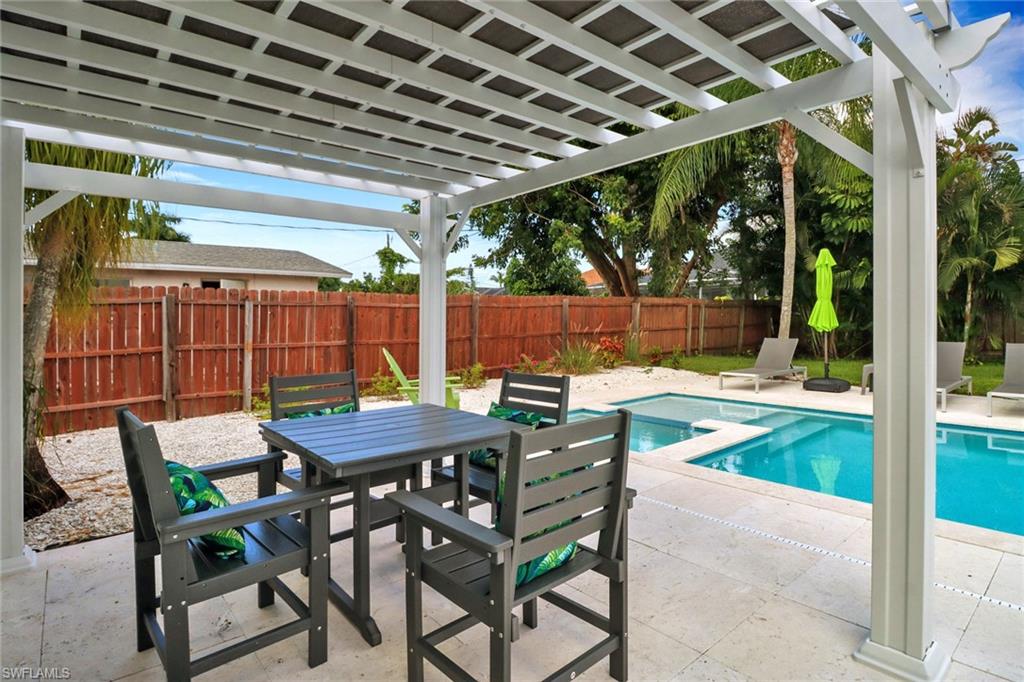 751 100th Avenue North Naples, FL 34108 - Photo 6 of 34 a view of a patio with a table and chairs
