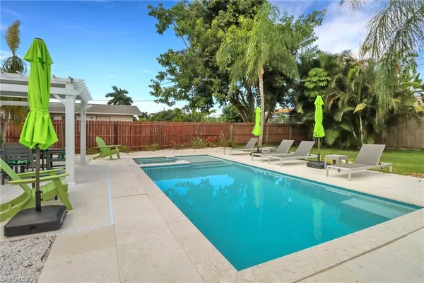 a swimming pool with outdoor seating and yard