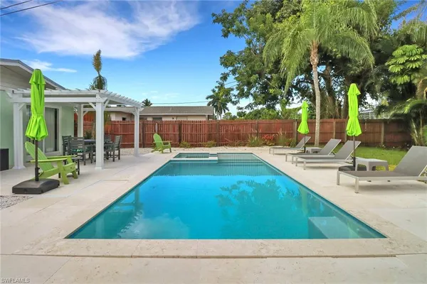 a swimming pool with outdoor seating and yard