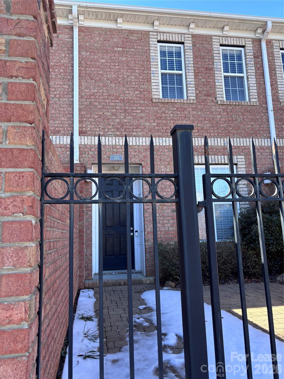 a view of a brick building with many windows