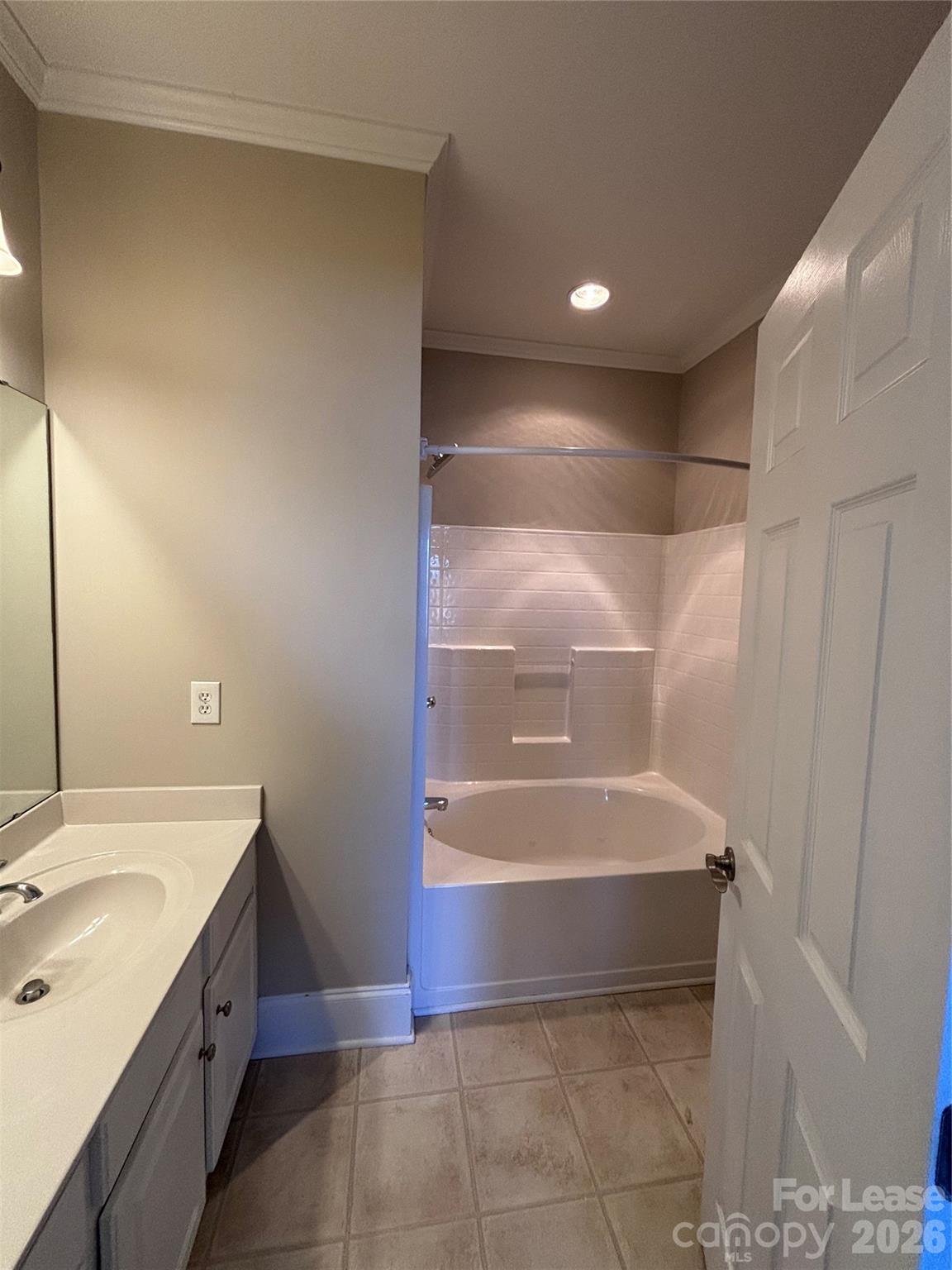 373 Dumbarton Street Concord, NC 28027 - Photo 12 of 18 a bathroom with a bathtub and a sink