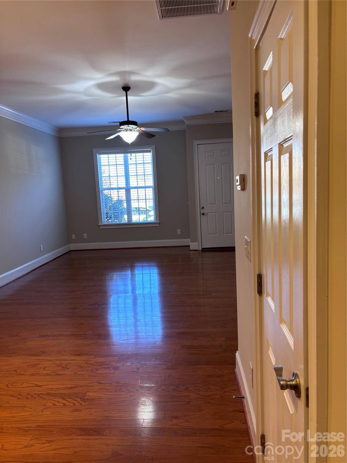 373 Dumbarton Street Concord, NC 28027 - Photo 2 of 18 wooden floor in an empty room with a window