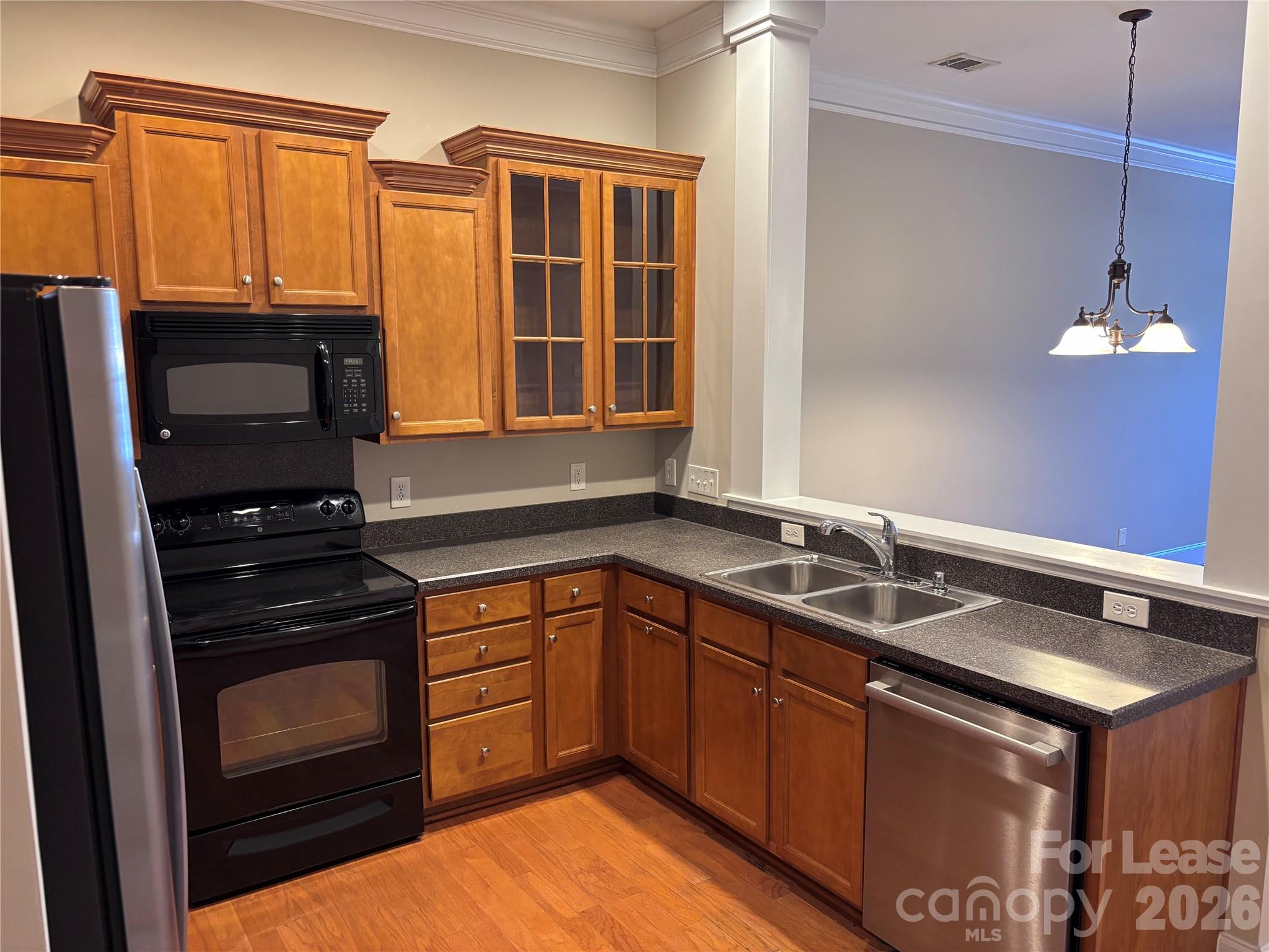 373 Dumbarton Street Concord, NC 28027 - Photo 4 of 18 a kitchen with a sink stove and microwave
