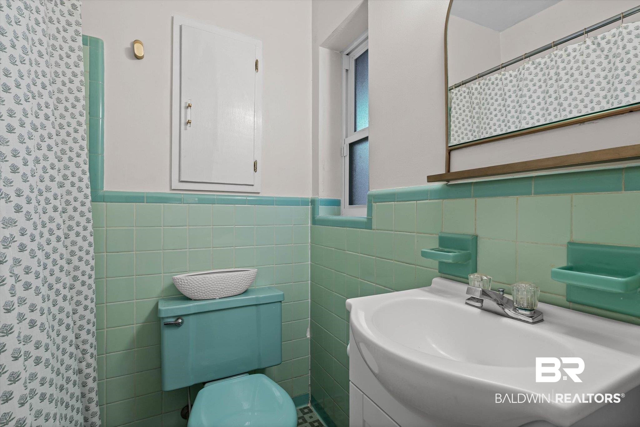 2103 Upham Court Mobile, AL 36607 - Photo 13 of 22 Full bathroom featuring a shower with shower curtain, vanity, tile walls, and a wainscoted wall
