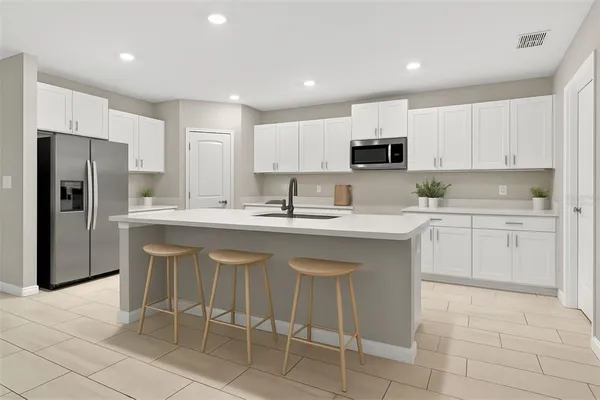 a kitchen with a sink cabinets and stainless steel appliances