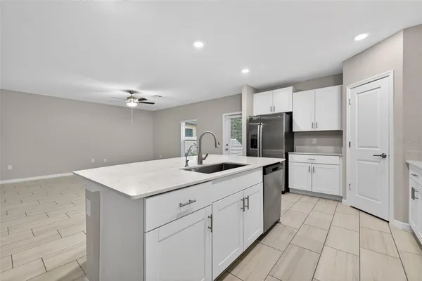 a kitchen with white cabinets appliances and sink