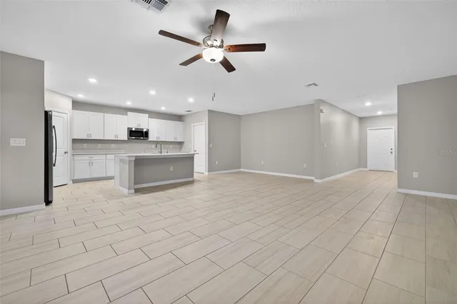 a view of a kitchen with a sink stainless steel appliances and cabinets