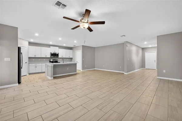 a view of a kitchen with a sink and a refrigerator