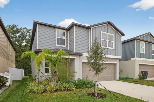wooden floor in an empty room with a ceiling fan