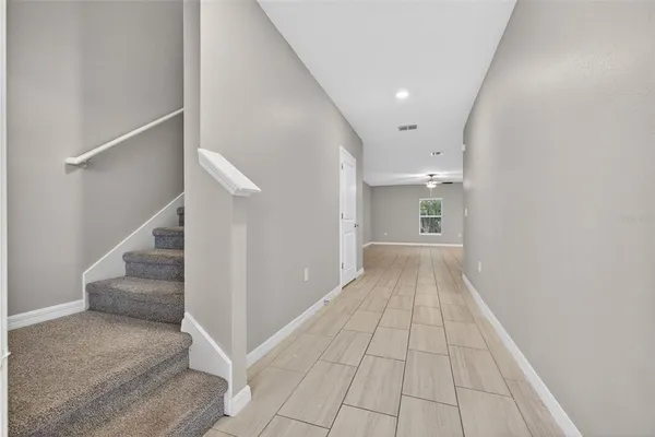 a view of a hallway view with staircase