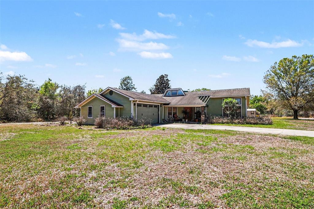 58 Deer Road Frostproof, FL 33843 - Photo 5 of 20 a front view of a house with a garden and yard