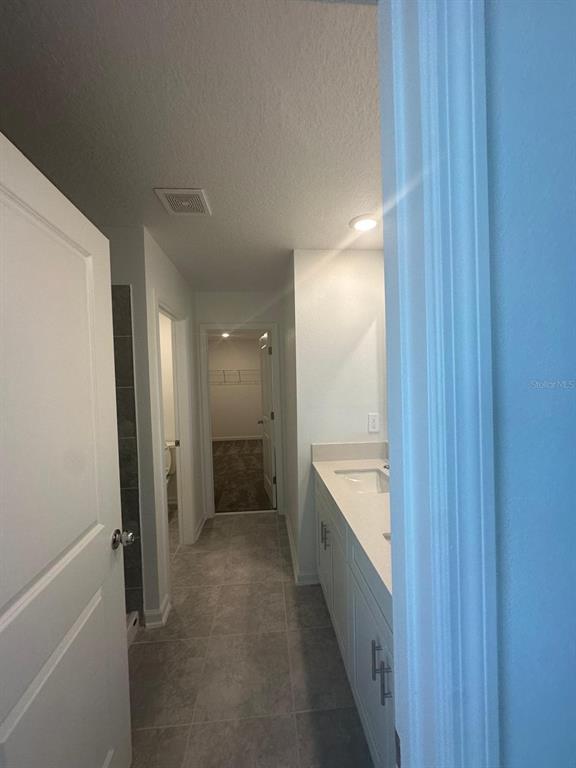 1559 Marksman Road Eagle Lake, FL 33839 - Photo 13 of 17 a bathroom with a granite countertop sink a toilet and shower