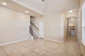 407 Epiphany Lane Pflugerville, TX 78660 - Photo 11 of 29 Empty room featuring arched walkways and a high ceiling