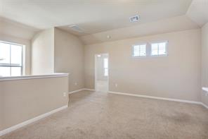 407 Epiphany Lane Pflugerville, TX 78660 - Photo 14 of 29 Carpeted spare room with baseboards and vaulted ceiling