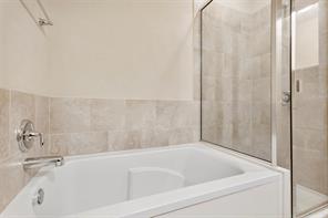 407 Epiphany Lane Pflugerville, TX 78660 - Photo 19 of 29 Bathroom with a stall shower and a garden tub