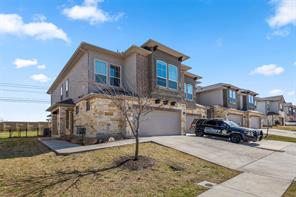 407 Epiphany Lane Pflugerville, TX 78660 - Photo 2 of 29 View of front facade featuring an attached garage, driveway, and stone siding
