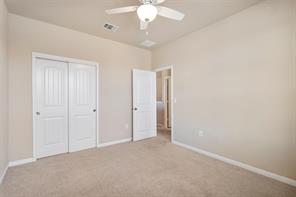407 Epiphany Lane Pflugerville, TX 78660 - Photo 23 of 29 Unfurnished bedroom featuring a closet, carpet flooring, and a ceiling fan