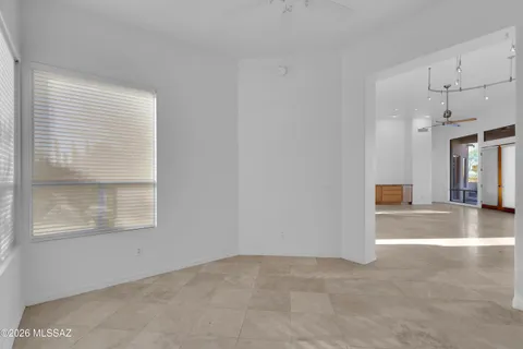 a view of a livingroom with a ceiling fan and window