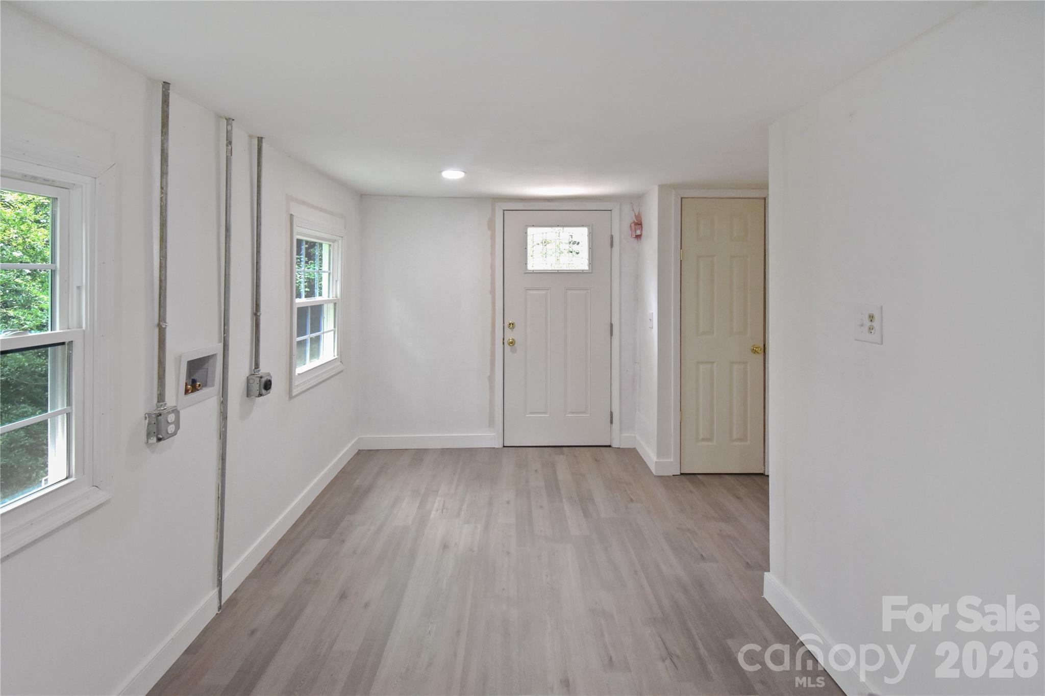 622 Green St Loop Marion, NC 28752 - Photo 10 of 16 an empty room with wooden floor and windows