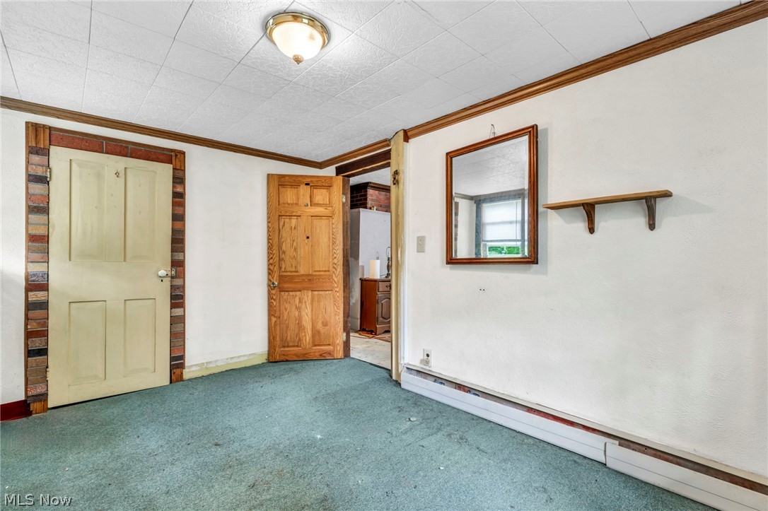 51464 North Ridge Road Vermilion, OH 44089 - Photo 24 of 37 Unfurnished bedroom with carpet flooring, a baseboard radiator, and ornamental molding