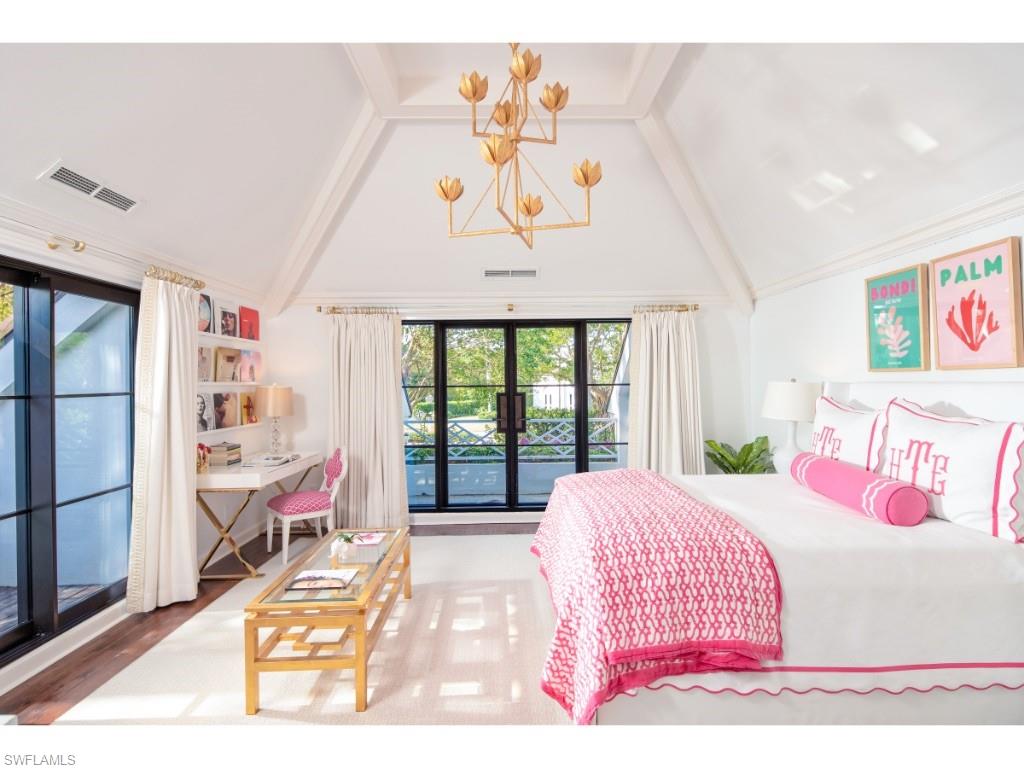 777 Kingstown Drive Naples, FL 34102 - Photo 12 of 18 a bedroom with a bed a large window with table and chairs