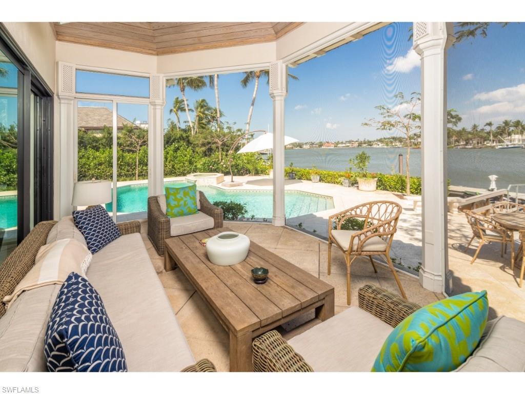 777 Kingstown Drive Naples, FL 34102 - Photo 16 of 18 a living room with patio furniture and a floor to ceiling window