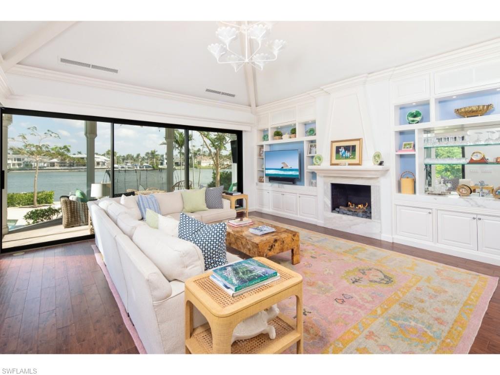 777 Kingstown Drive Naples, FL 34102 - Photo 4 of 18 a living room with furniture large window and a fireplace