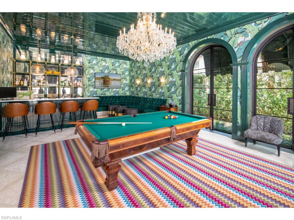 777 Kingstown Drive Naples, FL 34102 - Photo 6 of 18 a wooden bench sitting in front of a building