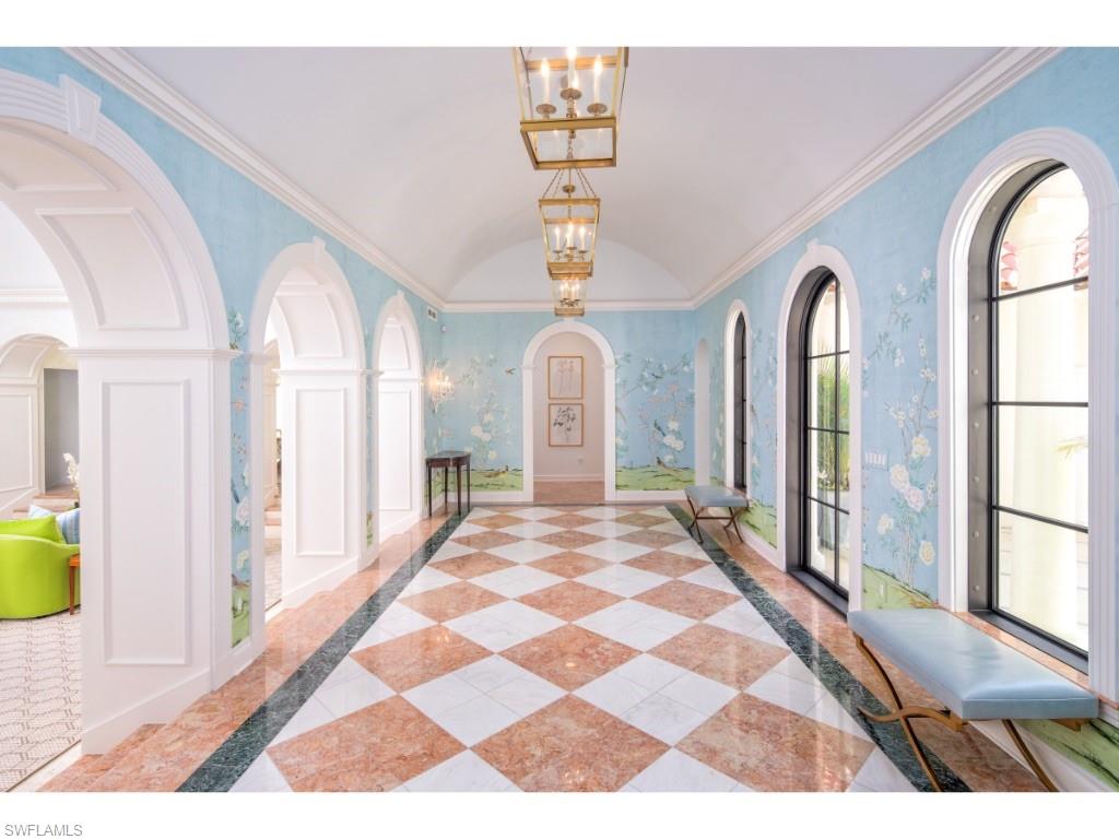 777 Kingstown Drive Naples, FL 34102 - Photo 7 of 18 a view of a hallway to front door with wooden floor