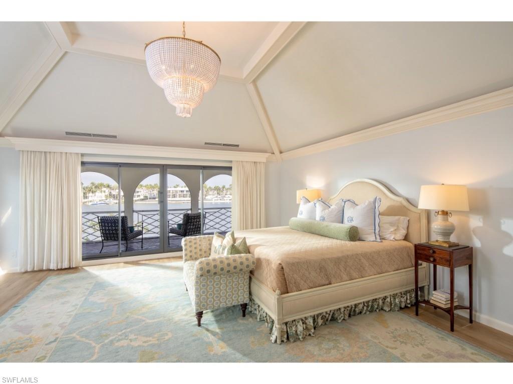 777 Kingstown Drive Naples, FL 34102 - Photo 10 of 18 a bedroom with a bed couch and large window