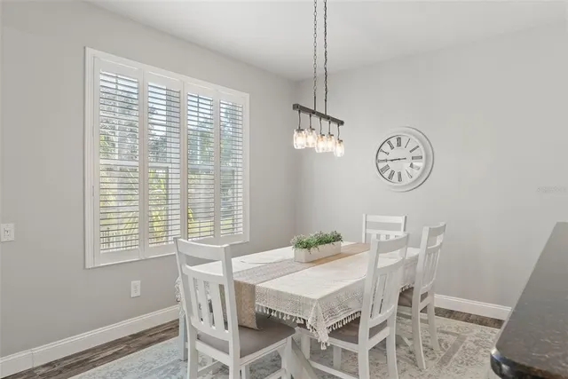 a kitchen with stainless steel appliances granite countertop a stove a sink and white cabinets