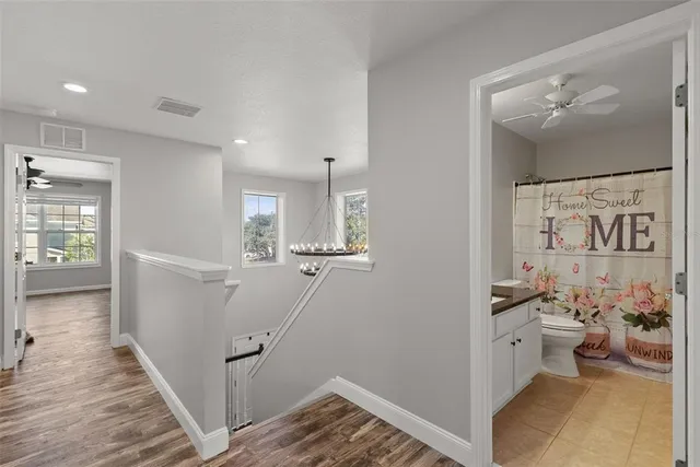 a spacious bathroom with a double vanity sink a mirror a bathtub and shower