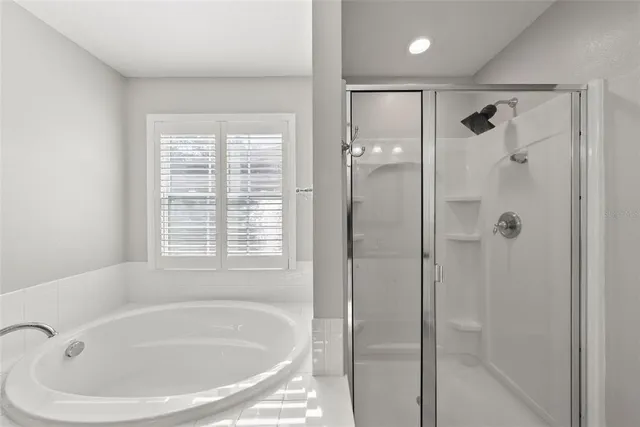 an empty room with wooden floor closet and windows